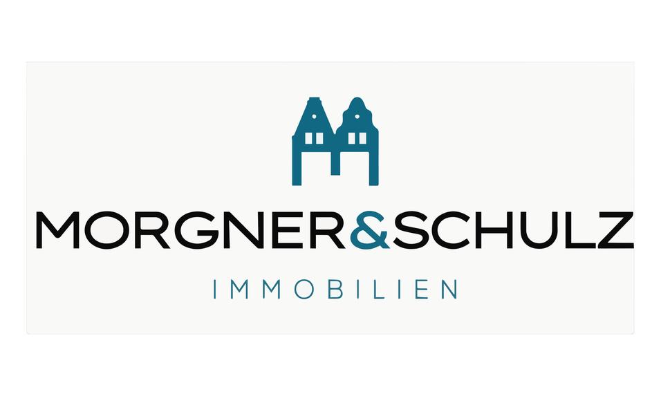 Logo der Firma Morgner & Schulz mit stilisierten Häusern und dem Schriftzug „IMMOBILIEN“.